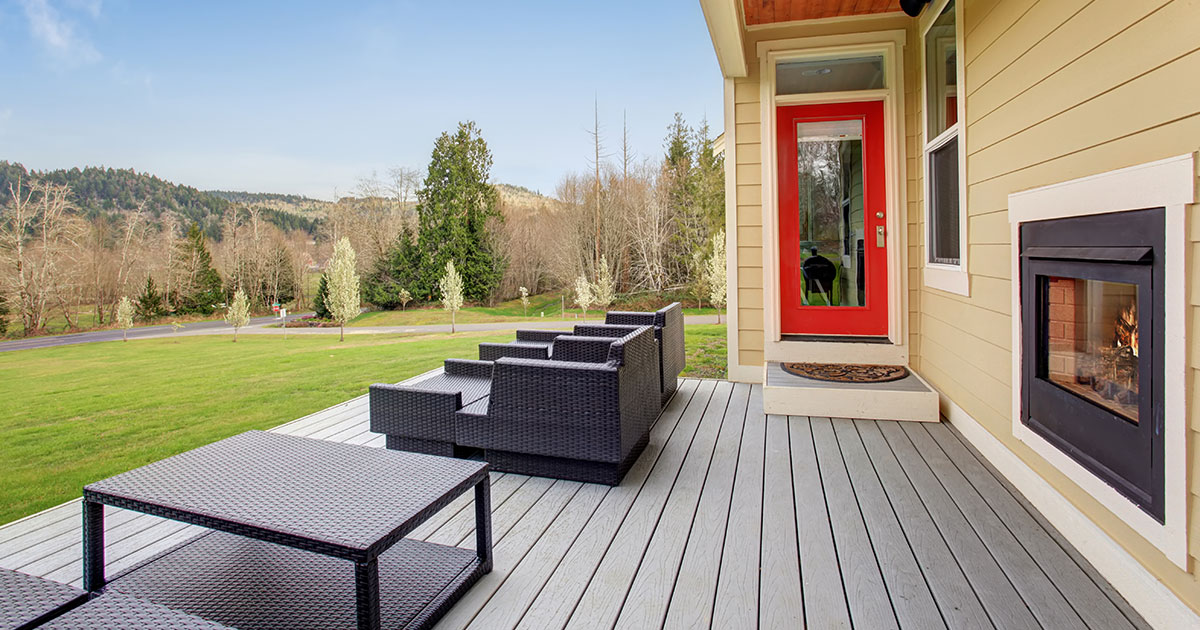 attached gray composite deck with outdoor furniture and garden view