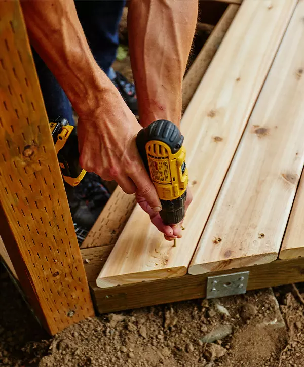 worker installing new wood decking boards, Deck Repair In Arvada CO